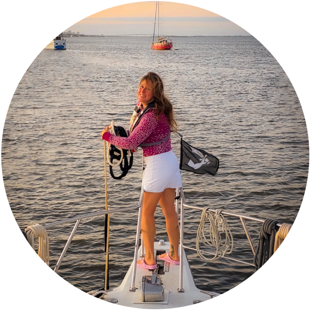 Elyse stands at the bow of the motor yacht Swamp Puppy, bringing up the bridle.