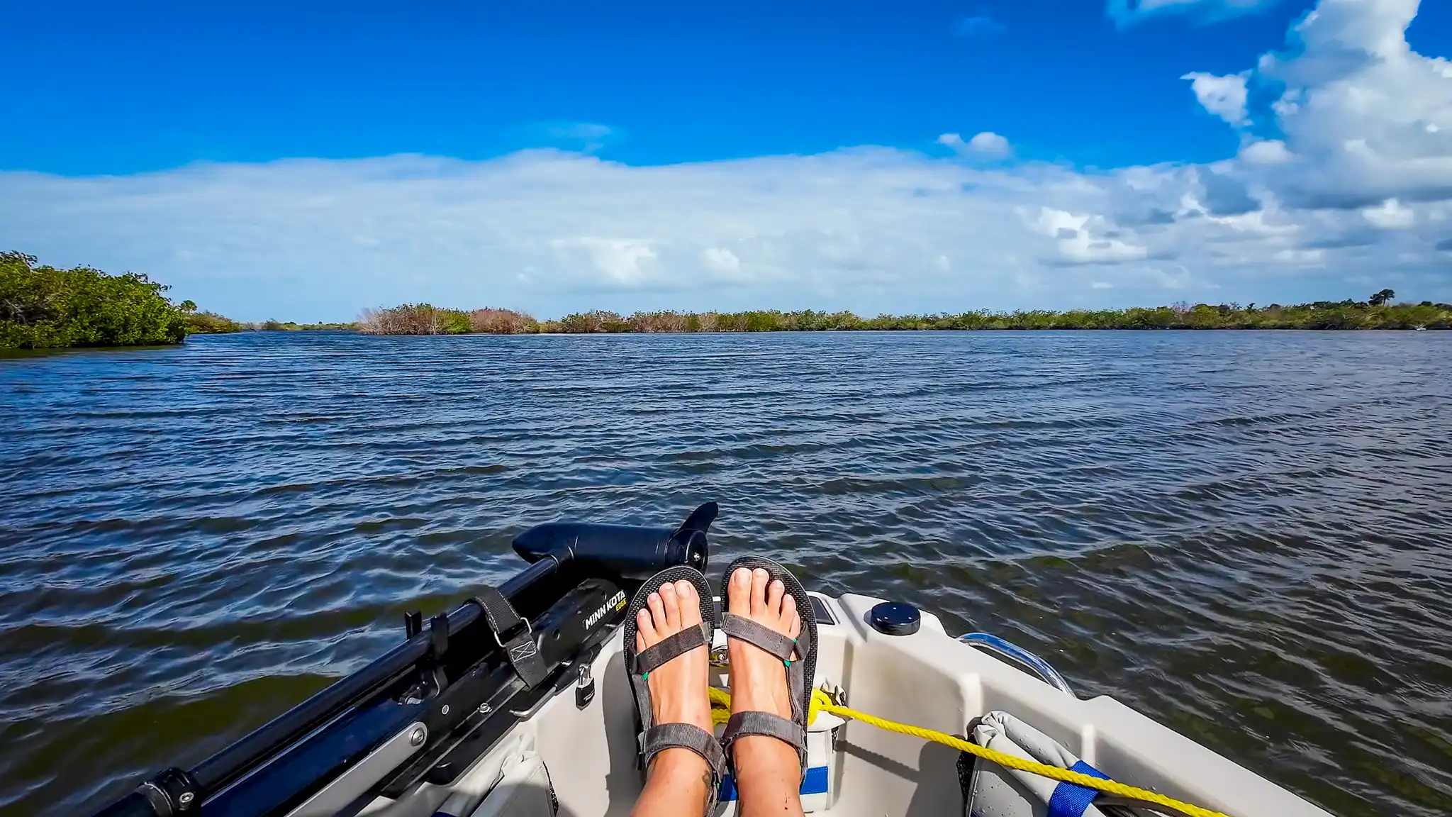 Elyse's feet at the front of their Mantus dinghy, while riding around Merritt Island.