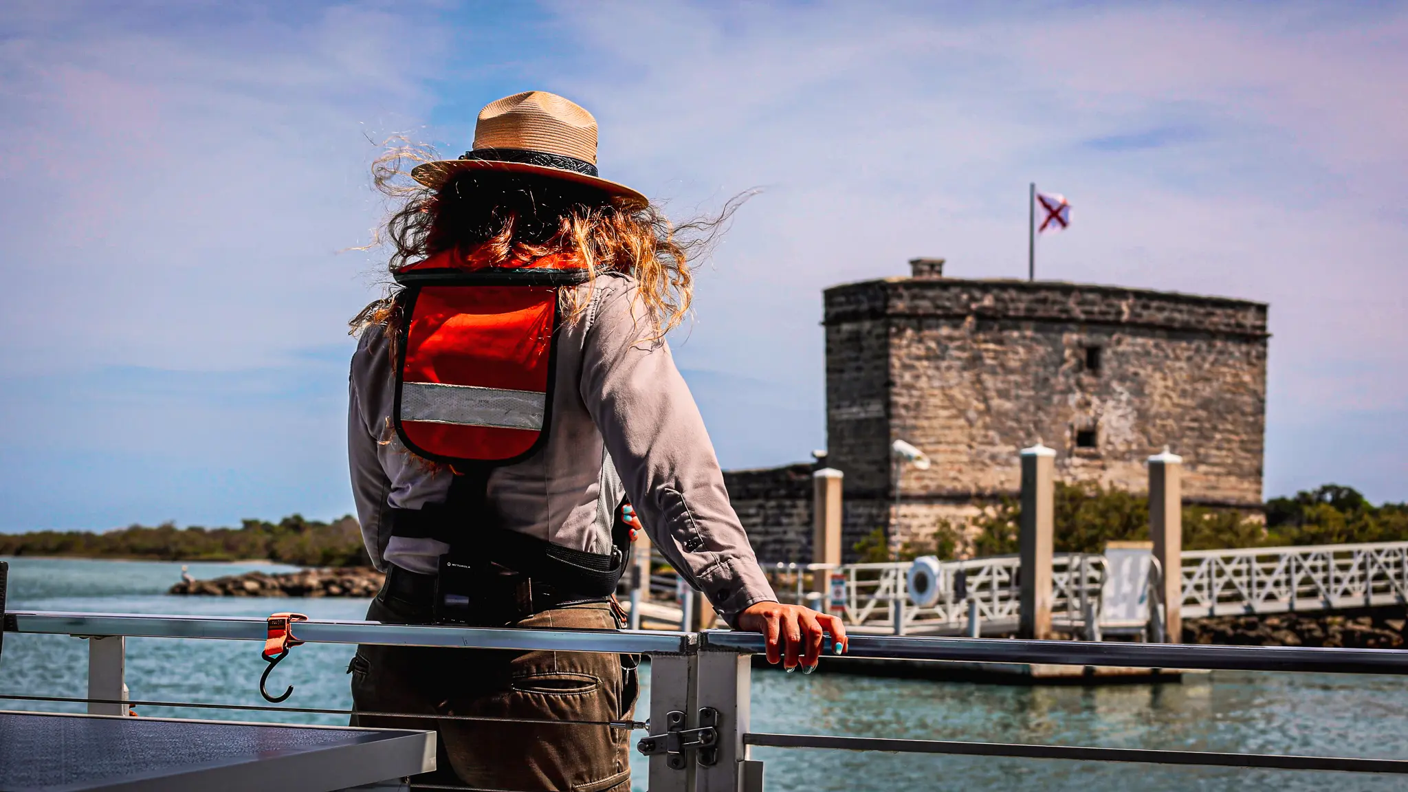 A female park ranger looking at Fort Matanzas from the ferry.