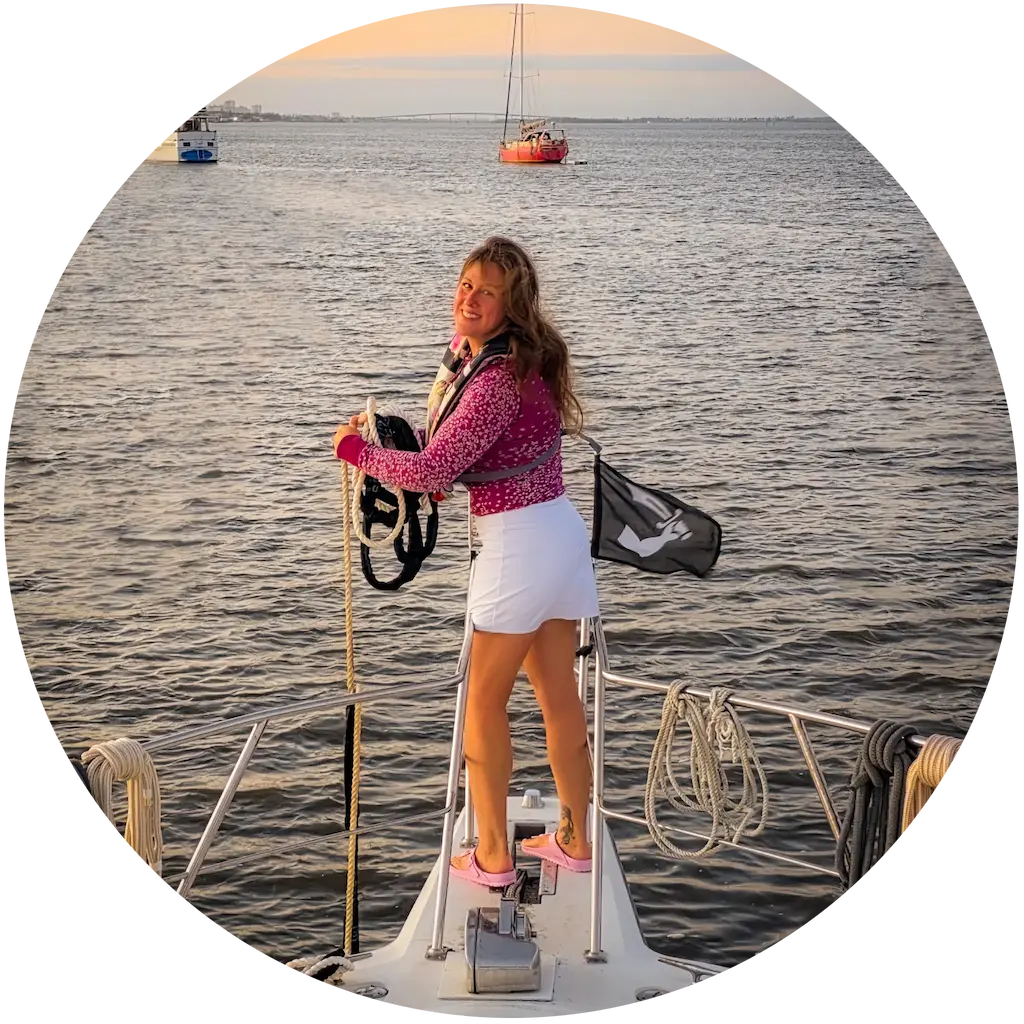 Elyse stands at the bow of the motor yacht Swamp Puppy, bringing up the bridle.