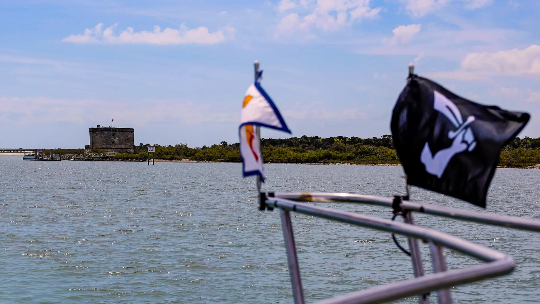 Fort Matanzas National Monument in the distance, our two Great Loop burgees flying on our bow.