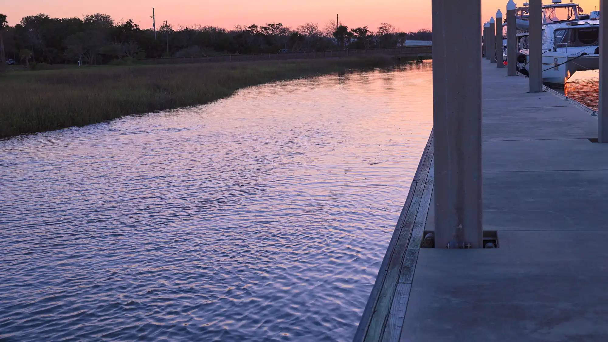 The free dock at Jim King Park at Sisters Creek at sunset.