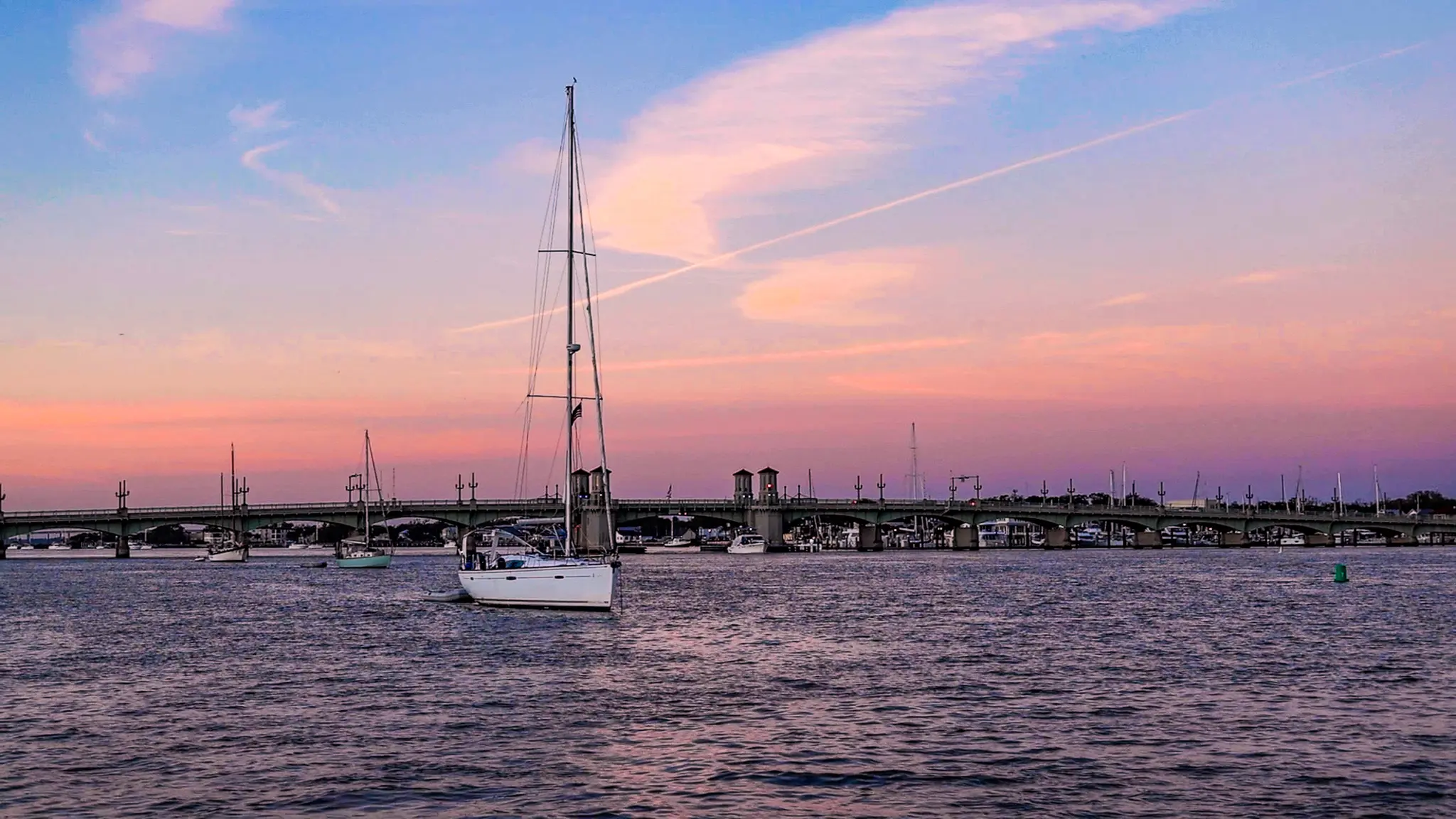 A pink sunset over the Bridge of Lions anchorage in St. Augustine, Florida.