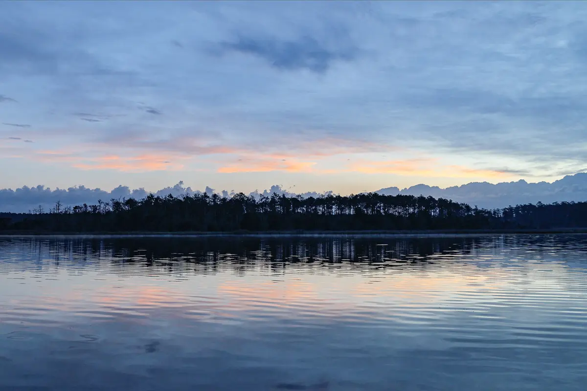 A subtle sunrise over the still waters of Goose Greek.